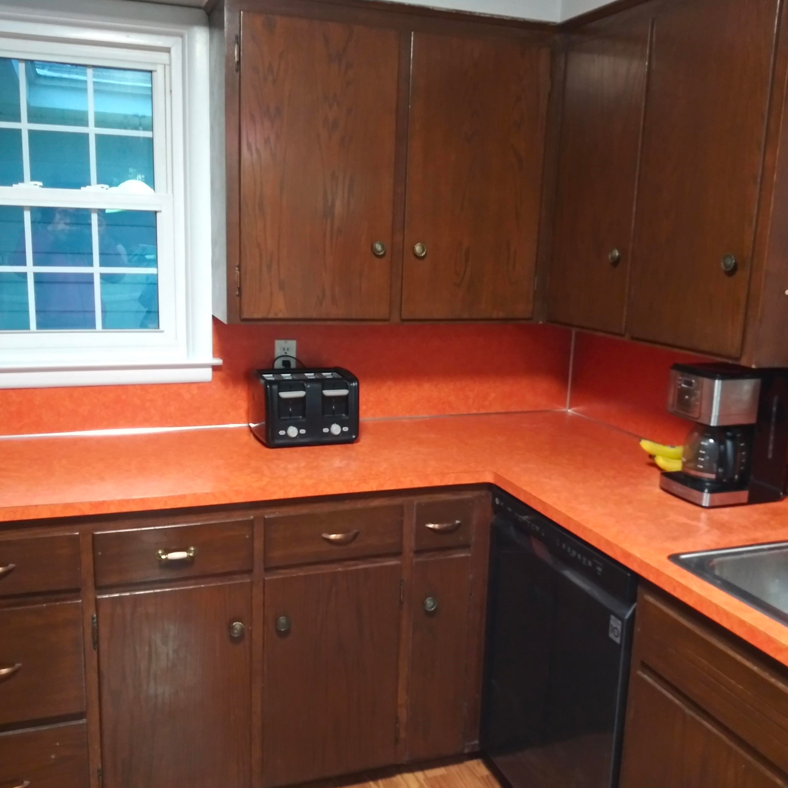 Entry 127 - This orange countertop & out of date cabinetry really date this kitchen